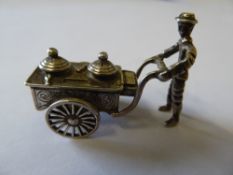 Very small model of a street vendor and handcart marked with Dutch silver hallmark, CS3; approx 4cms