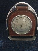 Barometer set in leather and hung within a stirrup