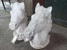 Pair of stone horse heads, measuring 50cms high; a/f