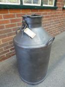 Tall antique milk churn