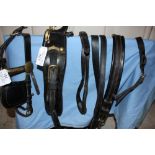 Set of black leather pony harness with brass fittings; no noseband or traces