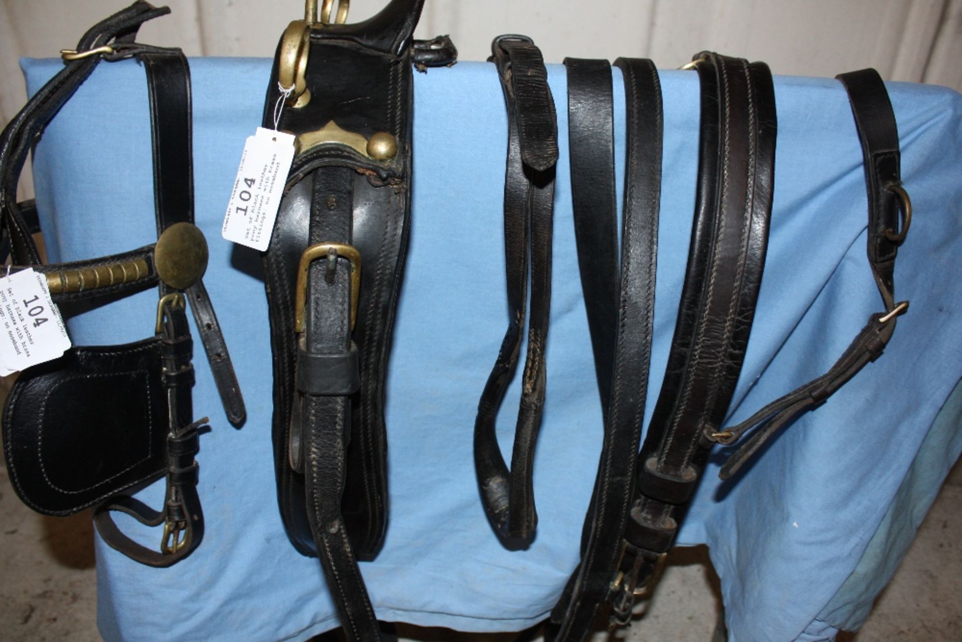 Set of black leather pony harness with brass fittings; no noseband or traces