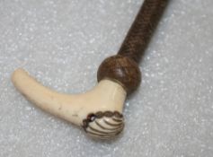 Side saddle whip with an ivory handle, inset with gemstone