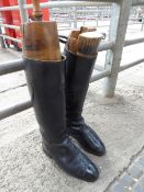 Pair of leather livery boots with wooden trees, measures 45cms high, 29.5cms length of foot