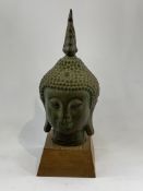 Bronze Budda head on plinth.