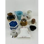 A collection of branded water jugs and ashtrays