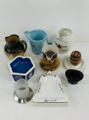 A collection of branded water jugs and ashtrays