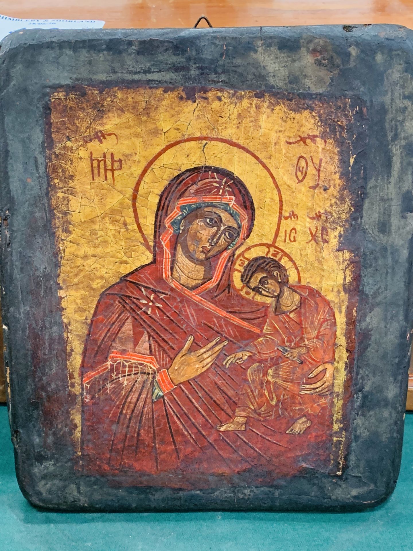 Hand painted Russian icon with gold leaf background and signature.