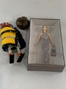 Georgio Armani Barbi doll, new in box; together with teak sculpture, and another doll