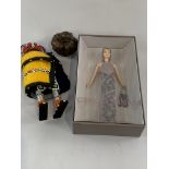 Georgio Armani Barbi doll, new in box; together with teak sculpture, and another doll