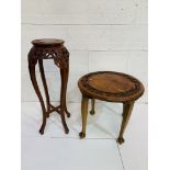 A circular carved oak table on four legs, and a hardwood pot stand.