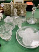 Four decanters, cut glass lidded pot, large goblet and two decorative glass plates.
