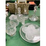 Four decanters, cut glass lidded pot, large goblet and two decorative glass plates.