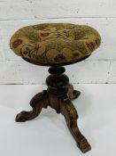 Late 19th century rise and fall padded piano stool with carved acanthus leaves.