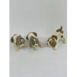 Three Lladro puppy figurines.