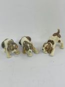 Three Lladro puppy figurines.