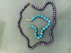 A turquoise bead bracelet and a black pearl necklace.