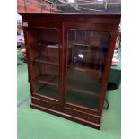 Mahogany glazed bookcase with 4 shelves over 2 drawers.