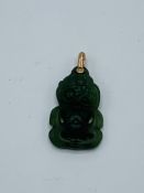 Antique nephrite Maori tiki pendant set with 9ct gold bale.