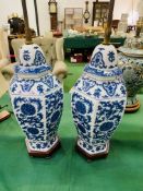 Pair of blue and white ceramic, height adjustable, two bulb table lamps.