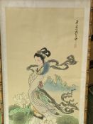 Bamboo framed and glazed Japanese painting on silk of a young lady in a garden, 68 x 33cms.