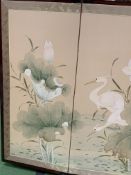 Four fold panel with painting on silk depicting storks and plants.