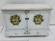 White painted cabinet with two cupboards over two drawers.