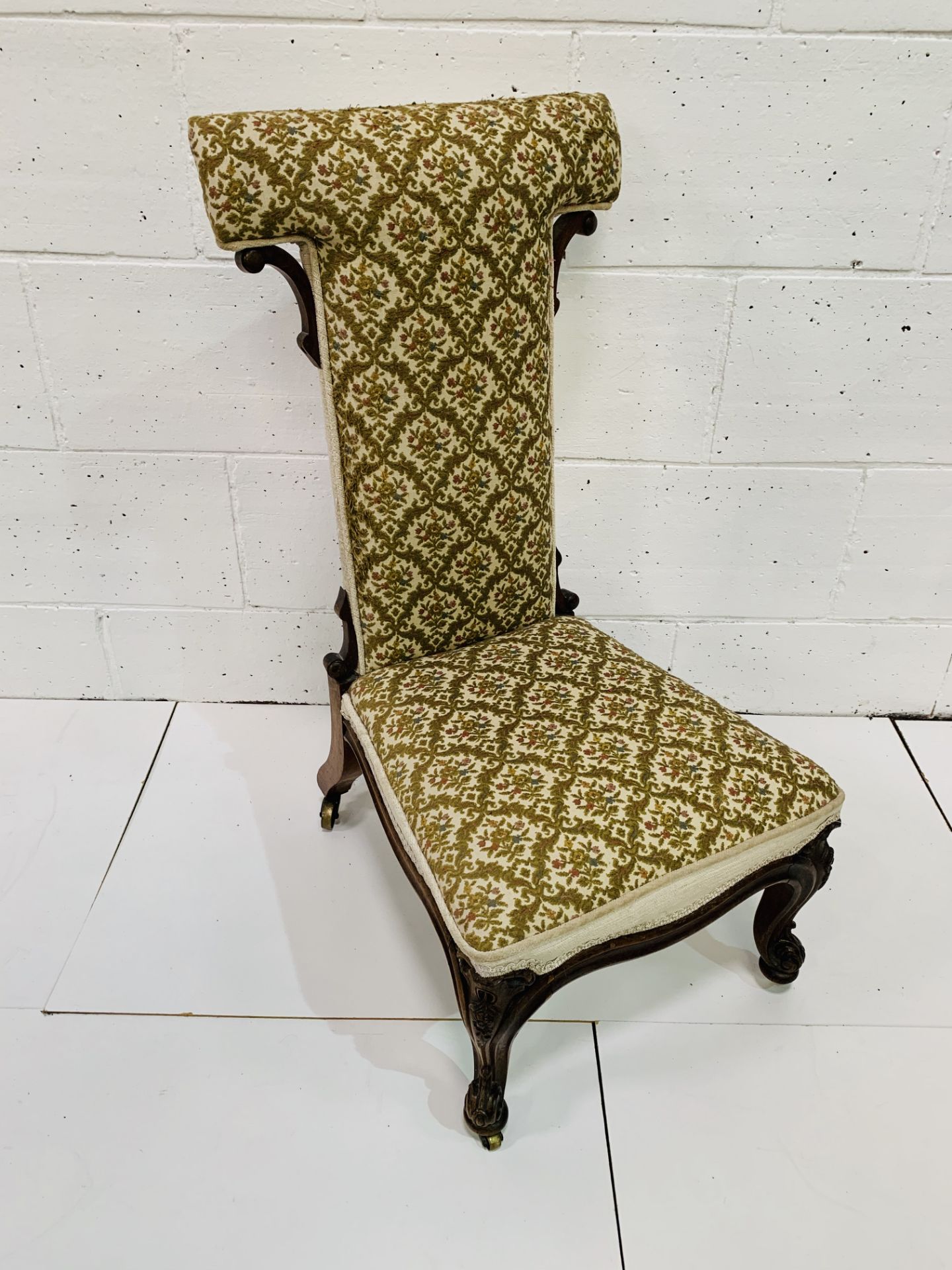 19th Century upholstered pridieu, with carved legs to casters.