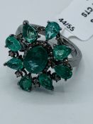 Emerald and diamond floral ring.