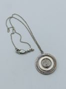 Silver medallion pendant necklace.