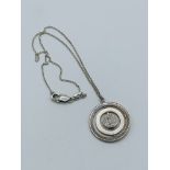 Silver medallion pendant necklace.