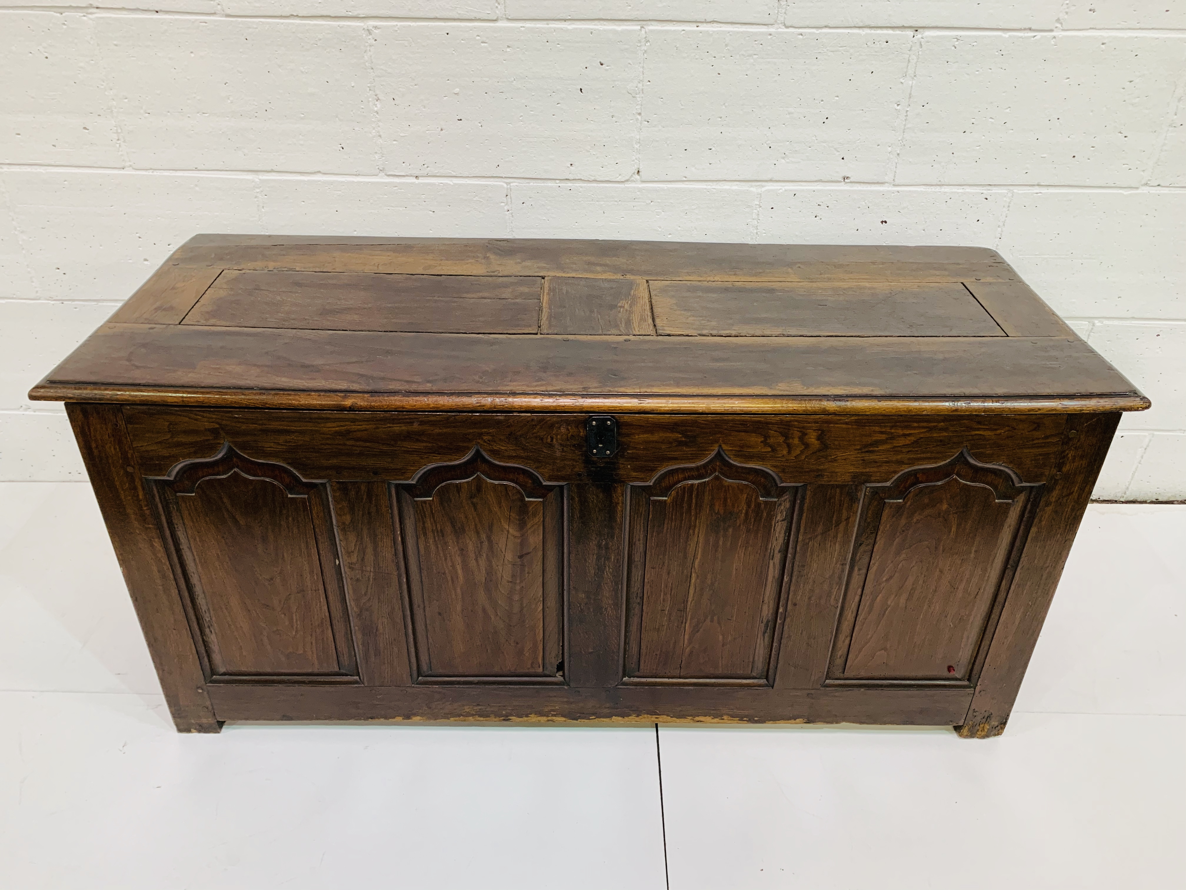 Large oak chest with four carved panels to front.