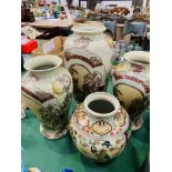 A pair and one other matching Oriental style vases, and another Oriental vase.