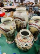 A pair and one other matching Oriental style vases, and another Oriental vase.