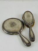 Silver backed dressing table mirror and matching hairbrush.