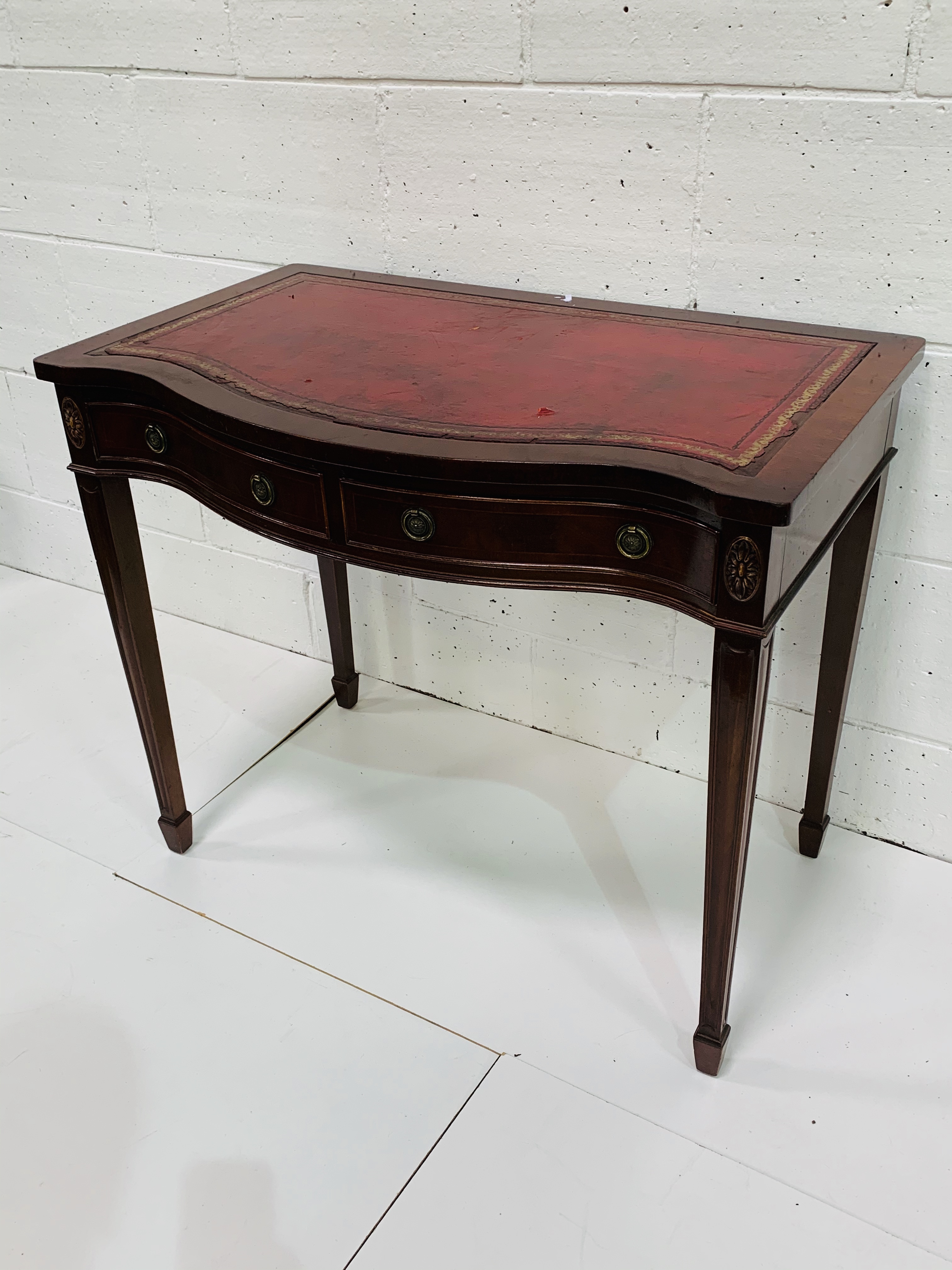 Mahogany serpentine fronted writing table.