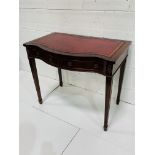 Mahogany serpentine fronted writing table.