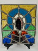 Pair of leaded floral and religious stained glass panels, 22 x 27.5cms.