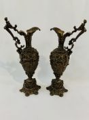 Pair of large Grecian ewers, bronzed and ornately cast with cherub handles.