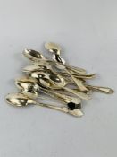 A collection of early 20th Century individual sterling silver tea spoons 200gms.