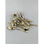 A collection of early 20th Century individual sterling silver tea spoons 200gms.