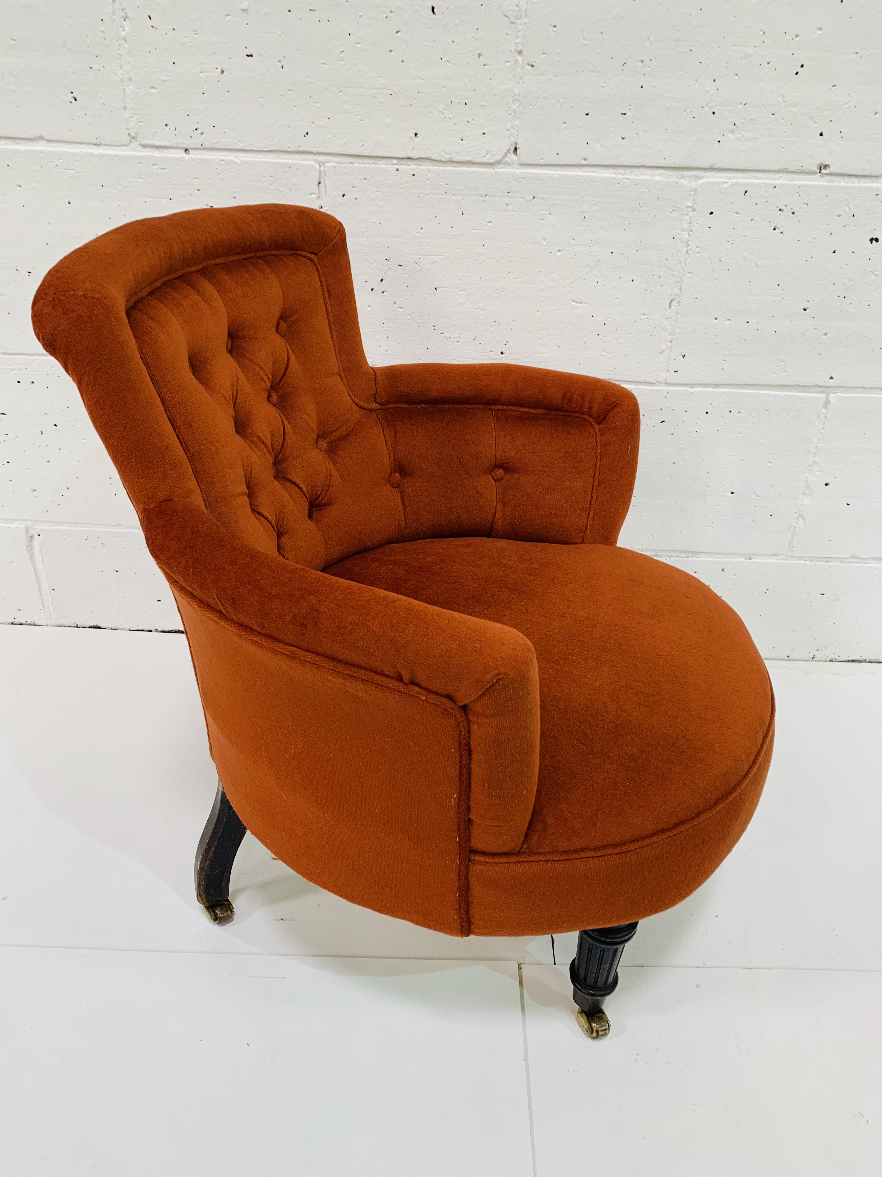 Small burnt orange tub chair, on turned front legs on casters. - Image 2 of 3