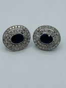 Sapphire and diamond oval cluster earrings.