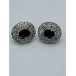 Sapphire and diamond oval cluster earrings.