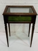 Mahogany display table with banded inlay and corded velvet lining on tapered legs.