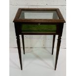 Mahogany display table with banded inlay and corded velvet lining on tapered legs.