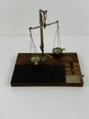 Set of small chemist's scales on stand complete with brass weights.