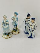 A pair of German porcelain figurines and another pair of porcelain figurines.