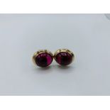 18ct yellow and white gold cuff links each set with with a single large ruby cabochon