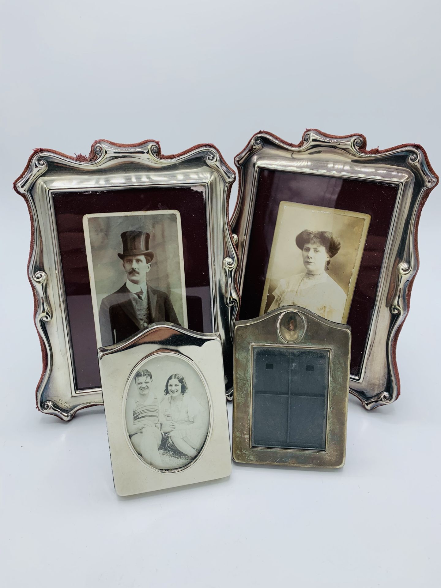 Pair of silver plated shaped photograph frames and 5 others